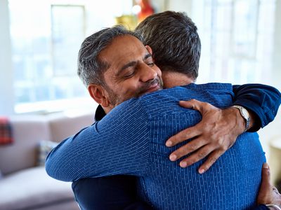 Best friends affectionately embracing, happiness, male bonding, comfort, confidence