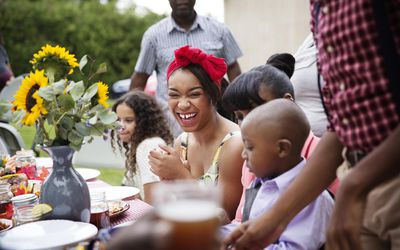 Teen Girl Laughing at Family Reunion Dinner