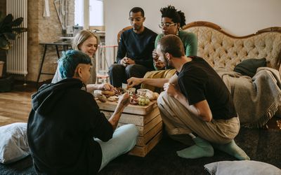 People having breakfast in living room 