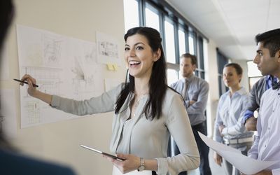 smiling woman leading discussion in office