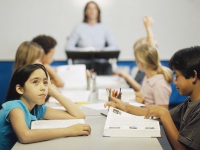 A girl daydreaming in class.