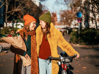 Lesbian couple taking romantic stroll in the fall