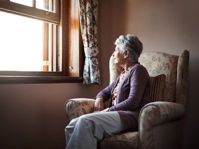 Shot of a senior woman sitting alone in her living room