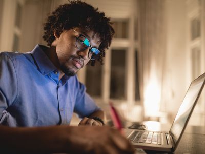 Young psychology student sitting at laptop writing an outline in APA style