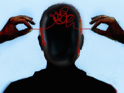 Hands untangling thread from inside of mans head