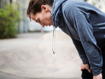 Woman bending over breathing deeply