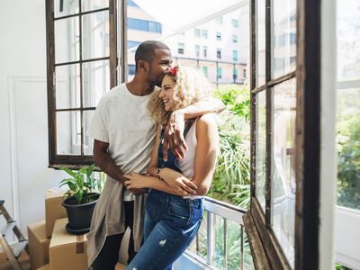 Young couple embraces in their apartment in Spain