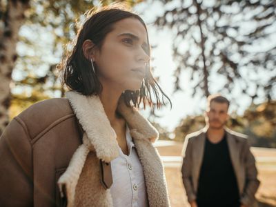 Man and woman in park in autumn, they are having relationship trouble