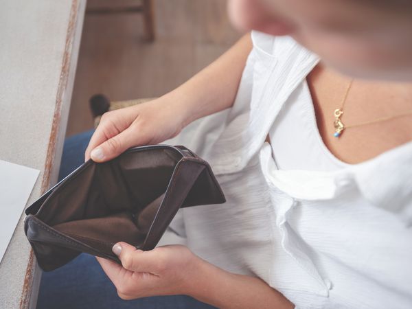 woman opening up an empty wallet