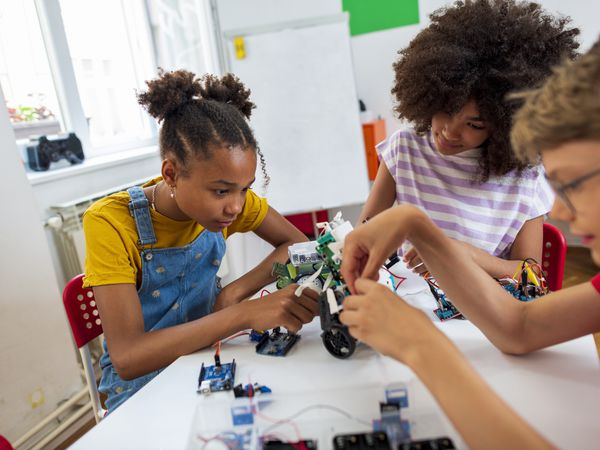 Diverse group of primary school students making robots at the science class