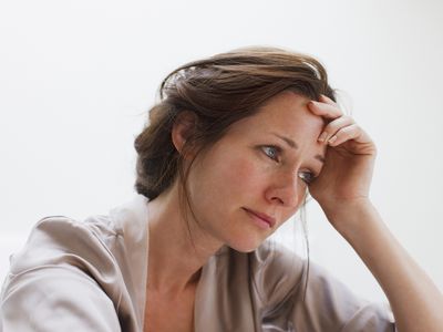 Depressed woman with head in hands.