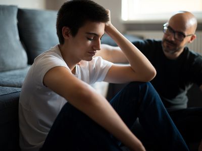 Upset young man talking with his father.