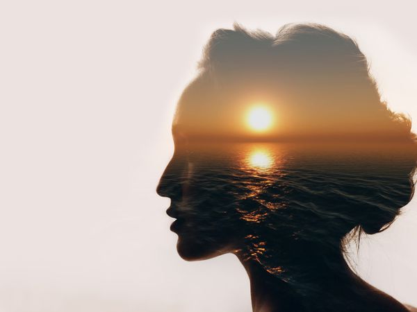 Sunrise and woman silhouette.