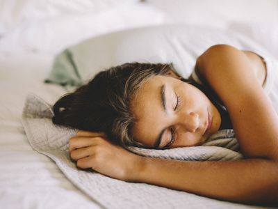 Girl sleeping on bed in morning