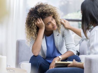 Depressed young woman talks to therapist