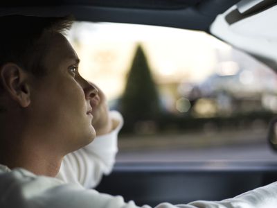 Man driving, lost in thought