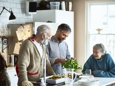 man and woman visiting with their adult son