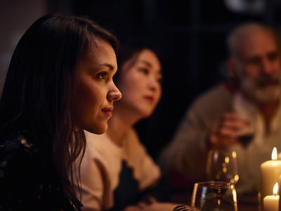 woman sitting quietly with friends at a restaurant