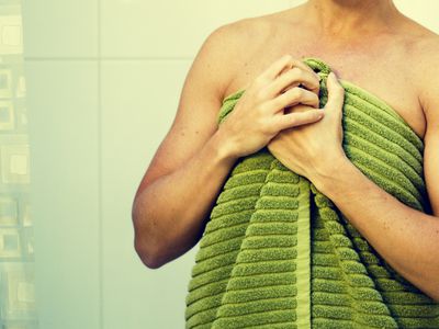 woman standing outside shower with towel on