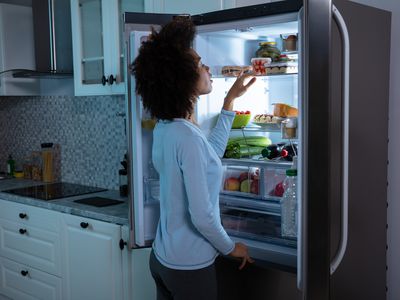 Woman Searching Food In Refrigerator