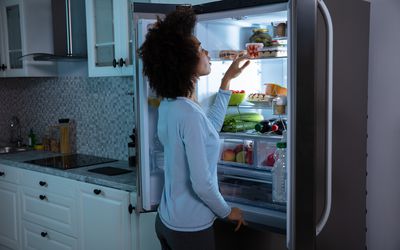 Woman Searching Food In Refrigerator