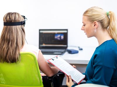 Young teenage girl and child therapist during EEG neurofeedback session