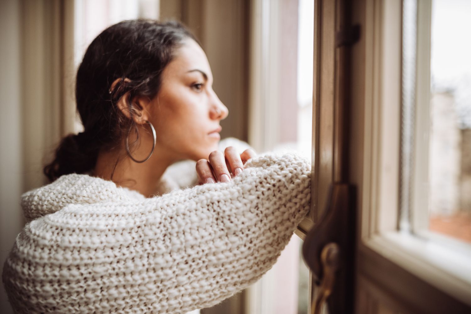 Pensive woman staring out the window