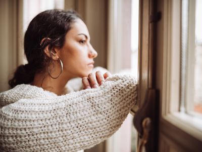 Pensive woman in front of the window 