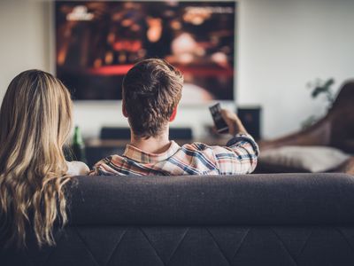 Rear view of a couple watching TV