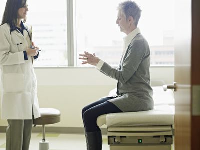 Doctor in discussion with patient in exam room