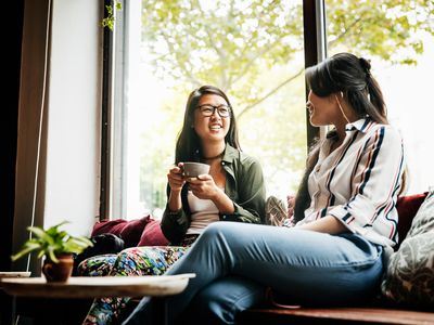 Two people talking over coffee