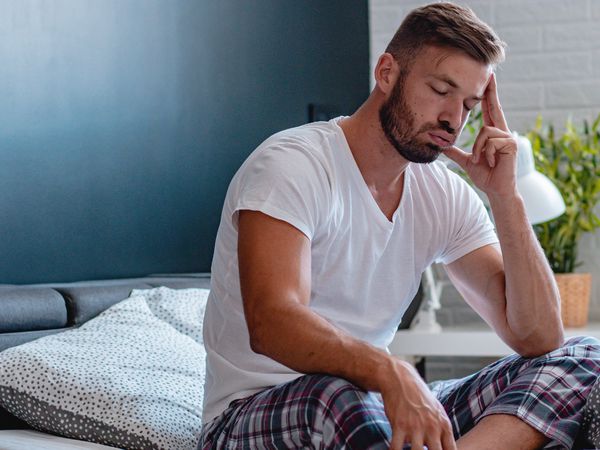 Young man feels pain in the head and fever