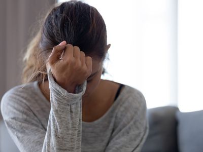 sad woman with head in one hand