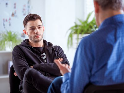 person having a serious conversation with their therapist