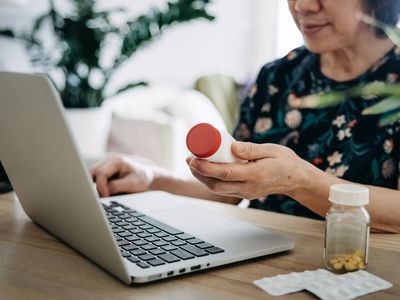 woman video conferencing with laptop to connect with her family doctor