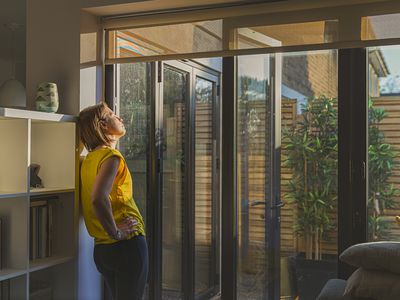 Woman standing by her back door