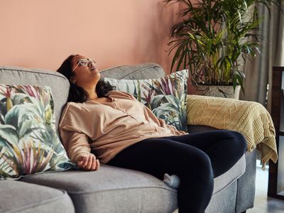 person looking tired on couch