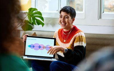 Cheerful young woman with laptop smiling