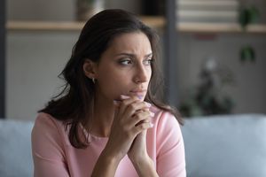 Anxious Arabic woman feel unhappy thinking at home