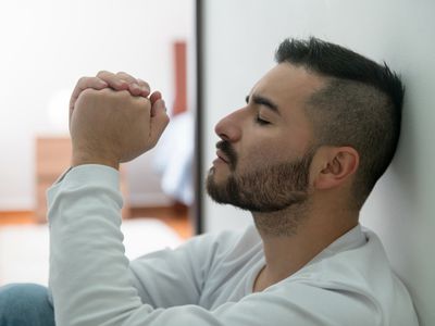 Portrait of a Latin American man at home struggling with depression - mental illness concepts