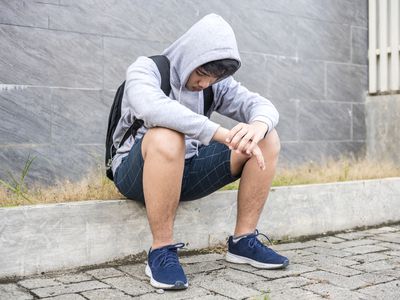  Teenage Boy Sitting looking sad 