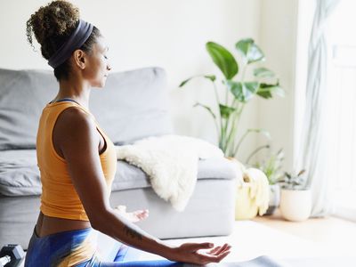 Woman sitting cross-legged meditating.