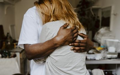 Son embracing mother in living room