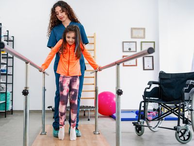 Young patient doing physiotherapy at a clinic with help of a therapist