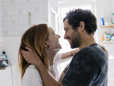 Couple Affectionately Embracing And Smiling Together