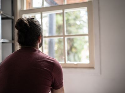 person looking out their window