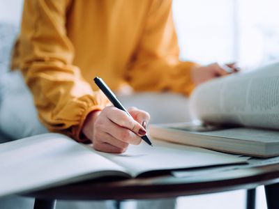 person reading and taking notes