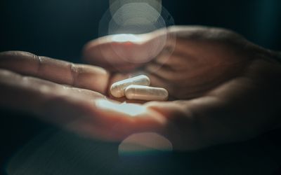 person holding pills in their hand