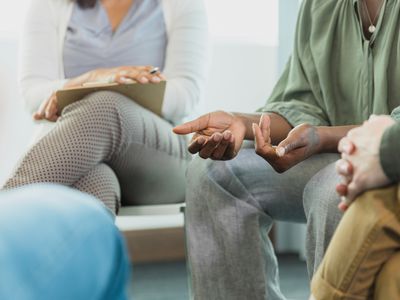 Focus on hands of woman sharing during group therapy