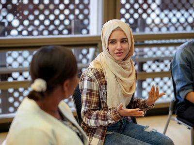 Muslim college students talking to a group in counseling